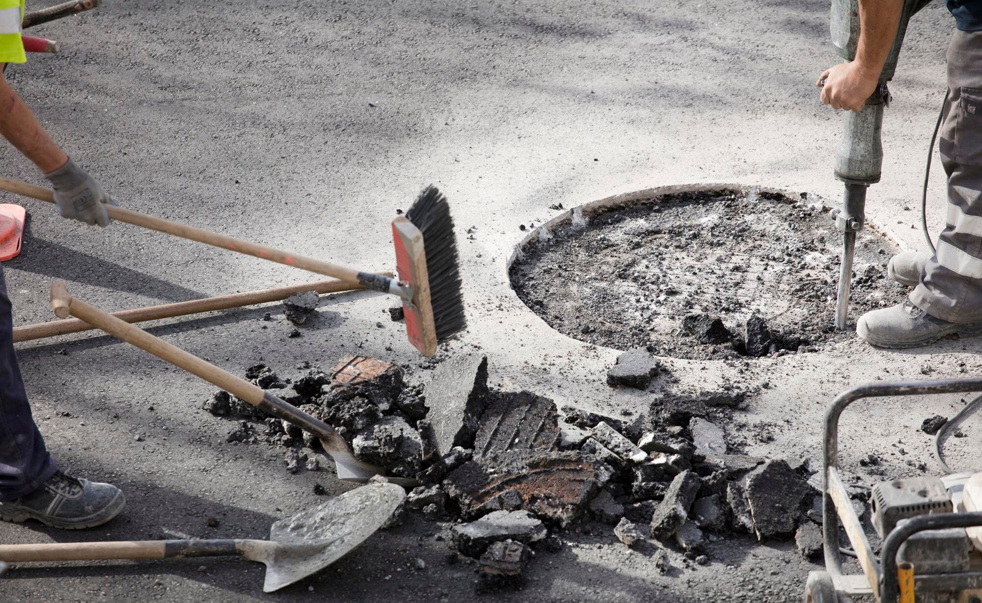Representative asphalt surface being prepared for pothole repair